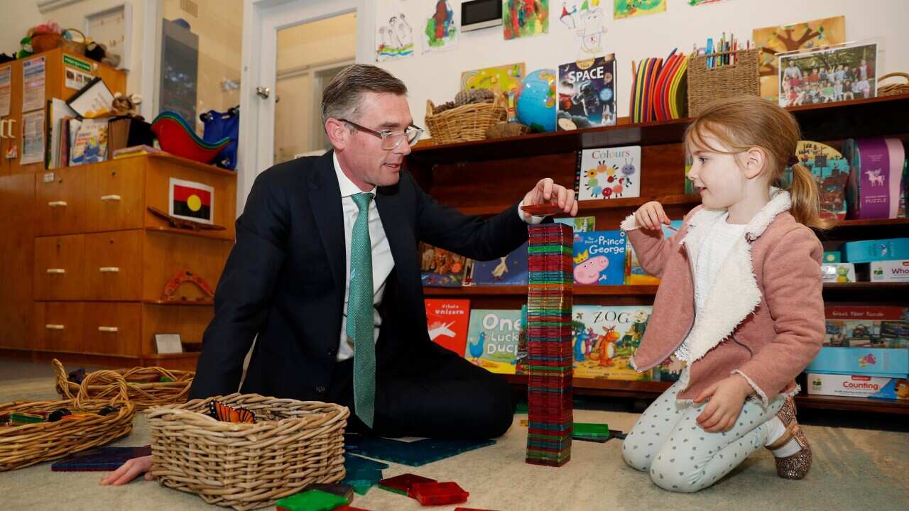 NSW Premier Dominic Perrottet plays with his daughter at a preschool in Sydney (AAP)