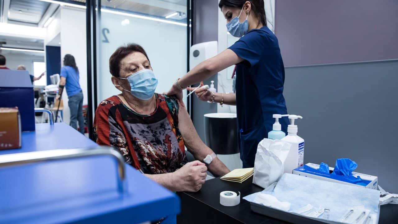 A woman receives her third dose of COVID-19 vaccine at Sheba Medical Centre in Ramat Gan, Israel.