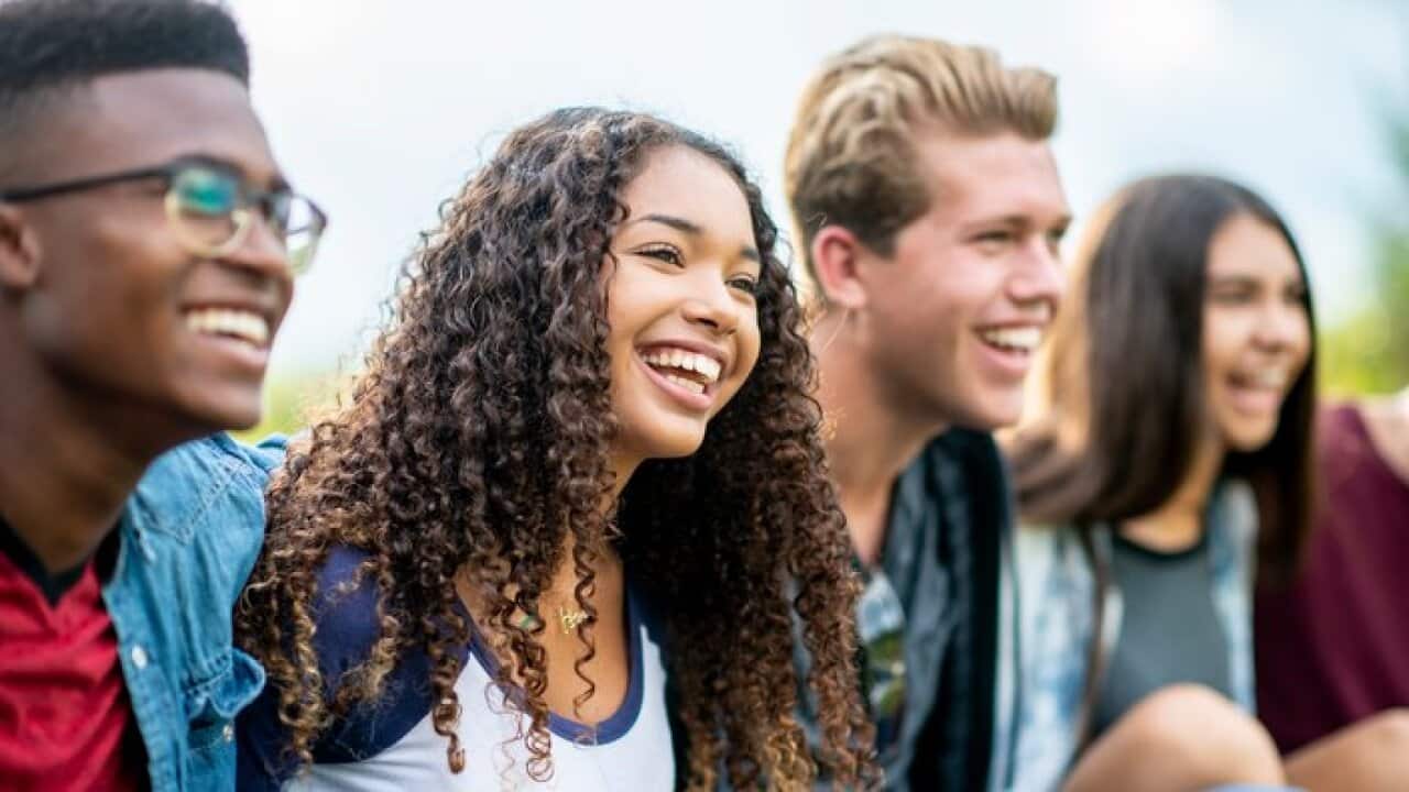 Teenage friends laughing outside