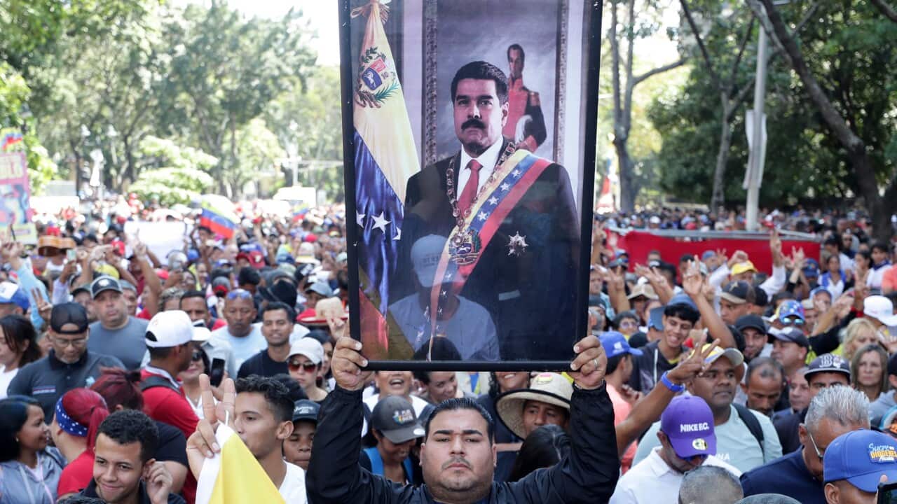 A man holds a picture of the captured President of Venezuela, Nicolas Maduro, during a march in support of the start of the National Assembly in Caracas, Venezuela, 05 January 2026.