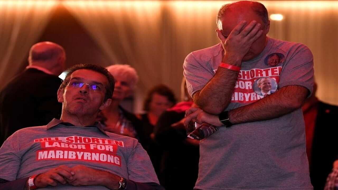 Labor supporters watch the tally count at the Federal Labor Reception.