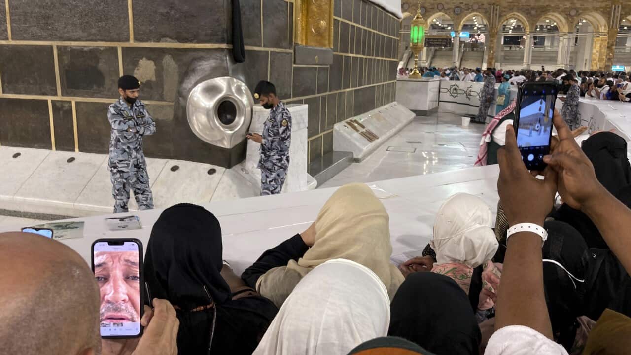 Muslim pilgrims film the Black Stone located on the Kaaba, the cubic building at the Grand Mosque, in the Saudi Arabia's holy city of Mecca,