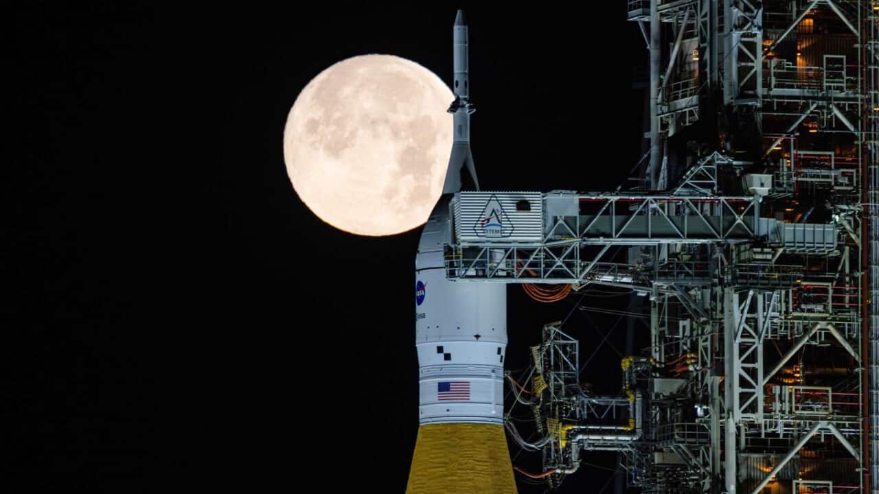 A full moon is seen shining over NASA’s SLS (Space Launch System) and Orion spacecraft, atop the mobile launcher in the early hours of Sunday, Feb. 1, 2026, at NASA’s Kennedy Space Center in Florida