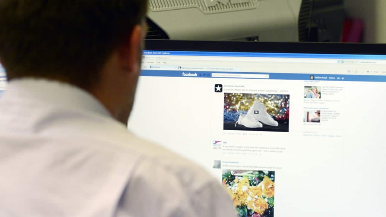 A man searches Facebook on a computer