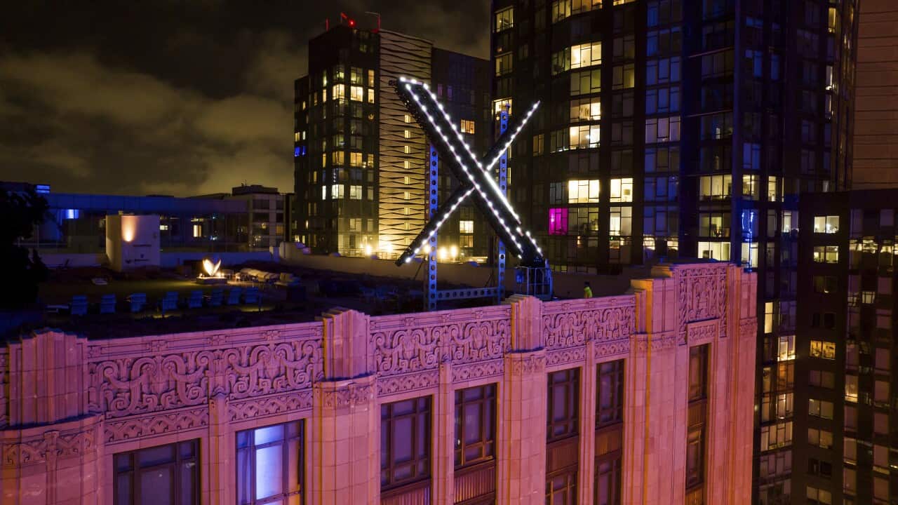 An X shaped sign on a building roof.