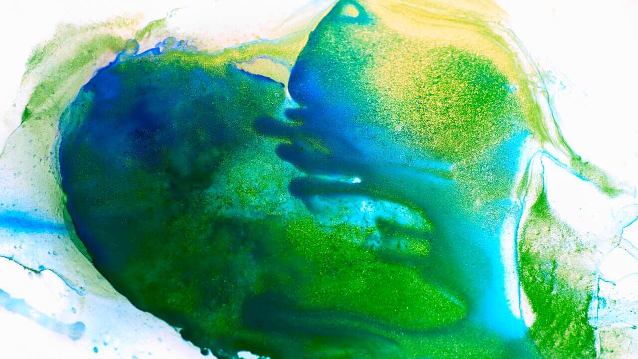 Heart shape spot of fluid, green and blue