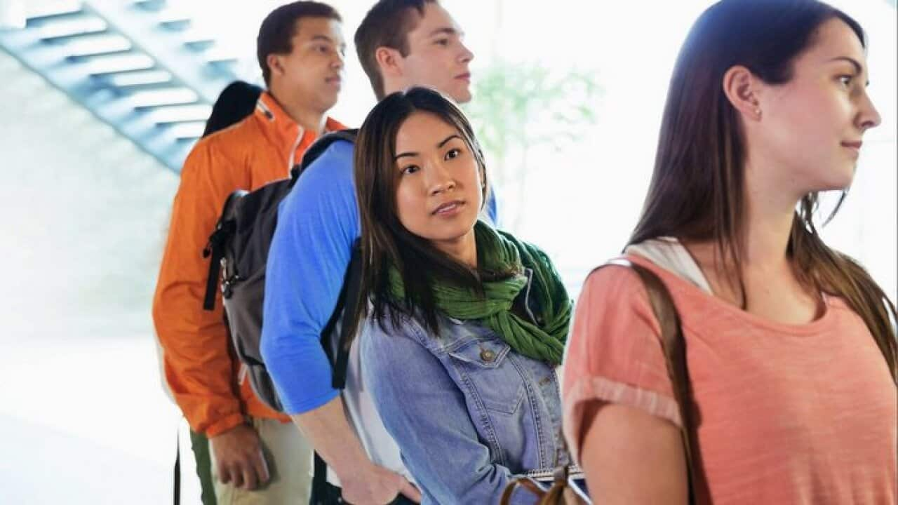 A group of people standing in a que