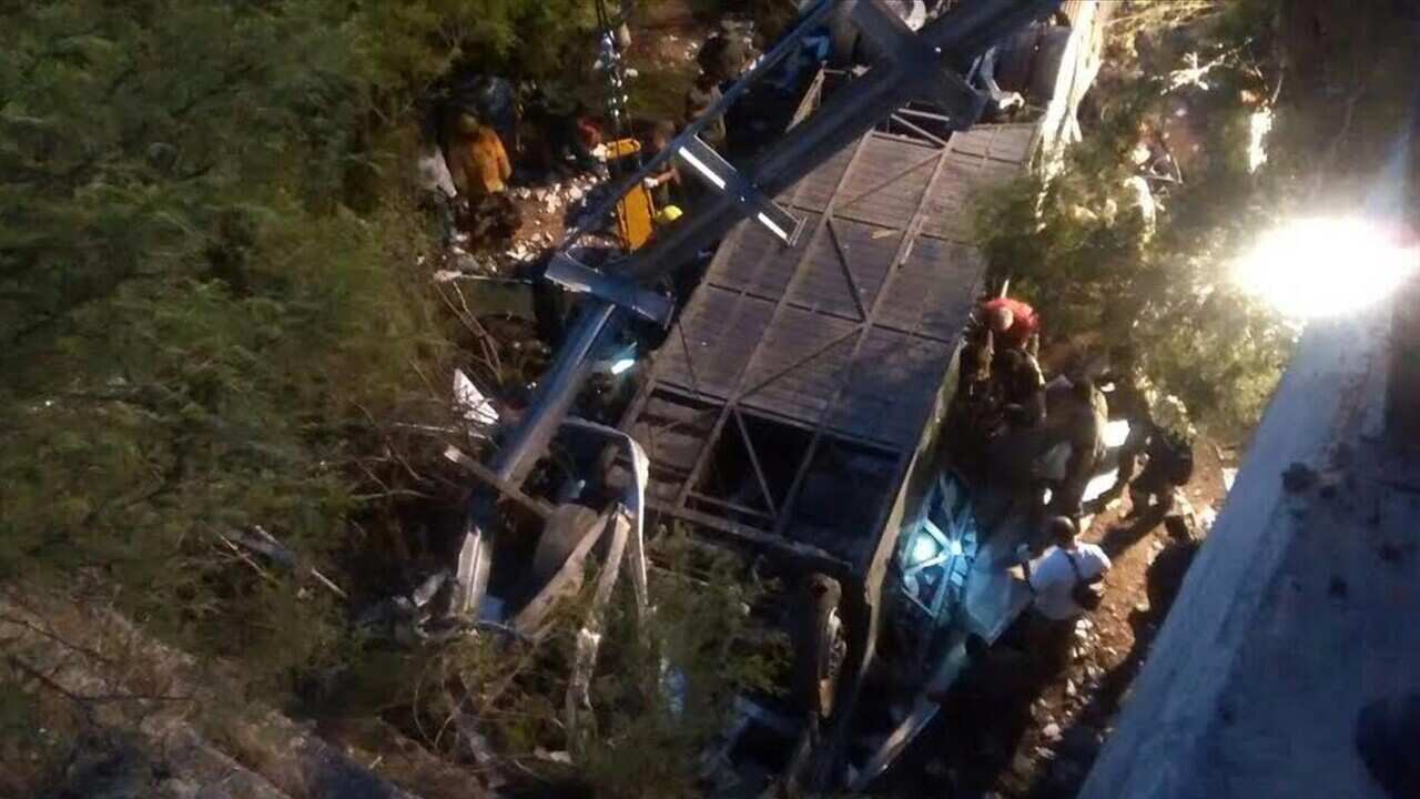 A handout picture provided by news website Trinuno Internet via Telam Agency shows people gather at the scene of a bus crash in northern Salta province, Argentina, 14 December 2015.