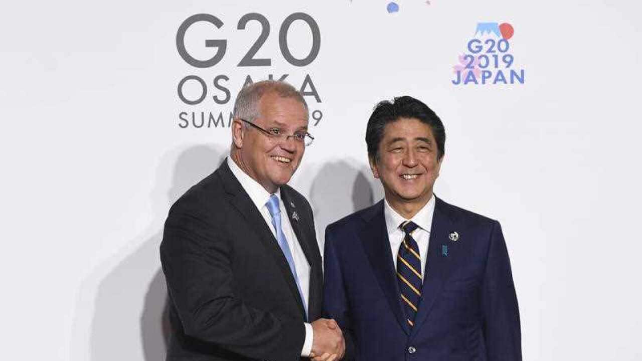 Prime Minister Scott Morrison shakes hands with Prime Minister of Japan Shinzo Abe during the Leaders Welcome at the G20 summit in Osaka