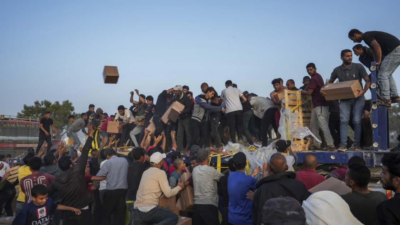 Palestinians descend on aid packages in the central Gaza Strip.
