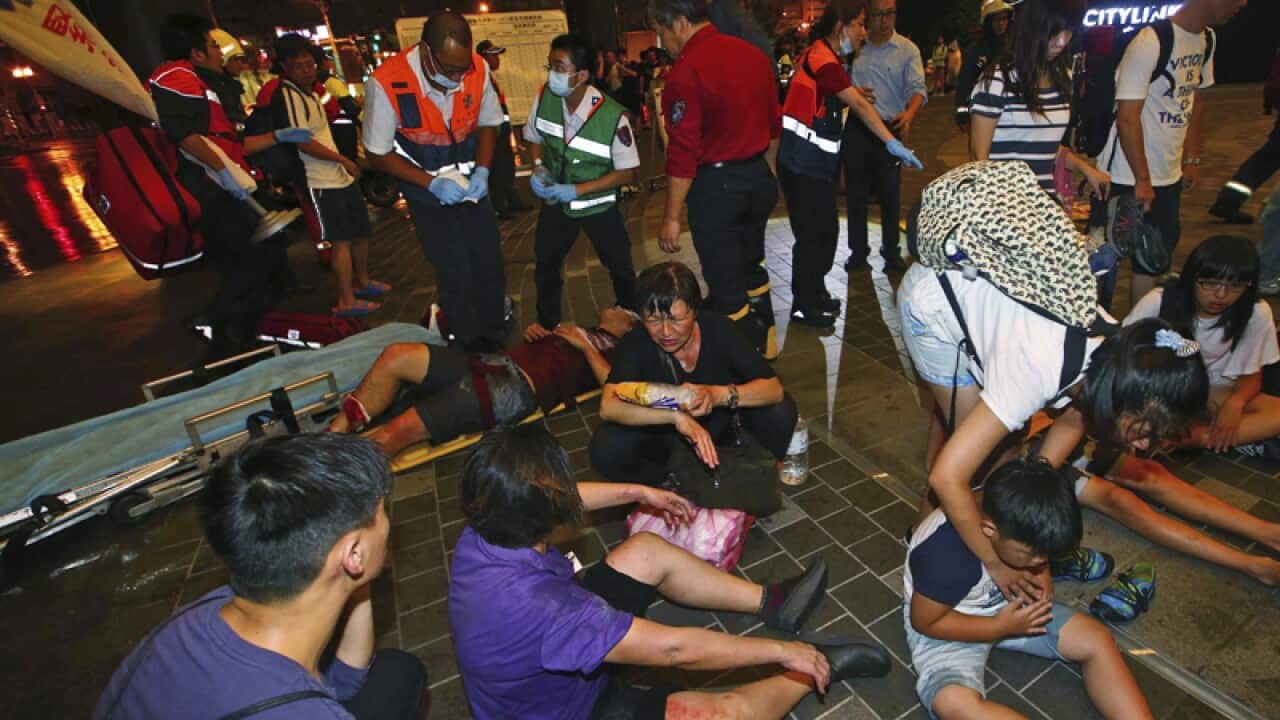 Injured people are helped by emergency rescue workers in Taipei