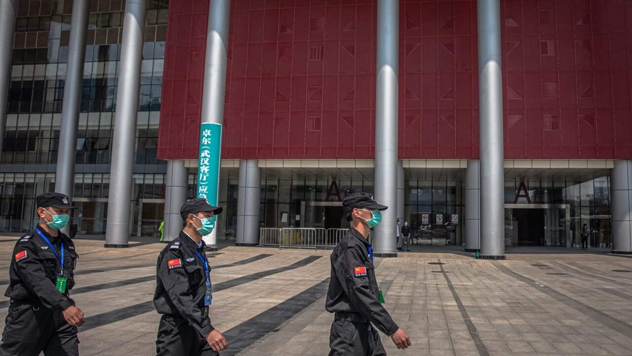 Security guards outside a convention center which was converted to a makeshift hospital and used to treat COVID-19 patients during the outbreak in Wuhan.