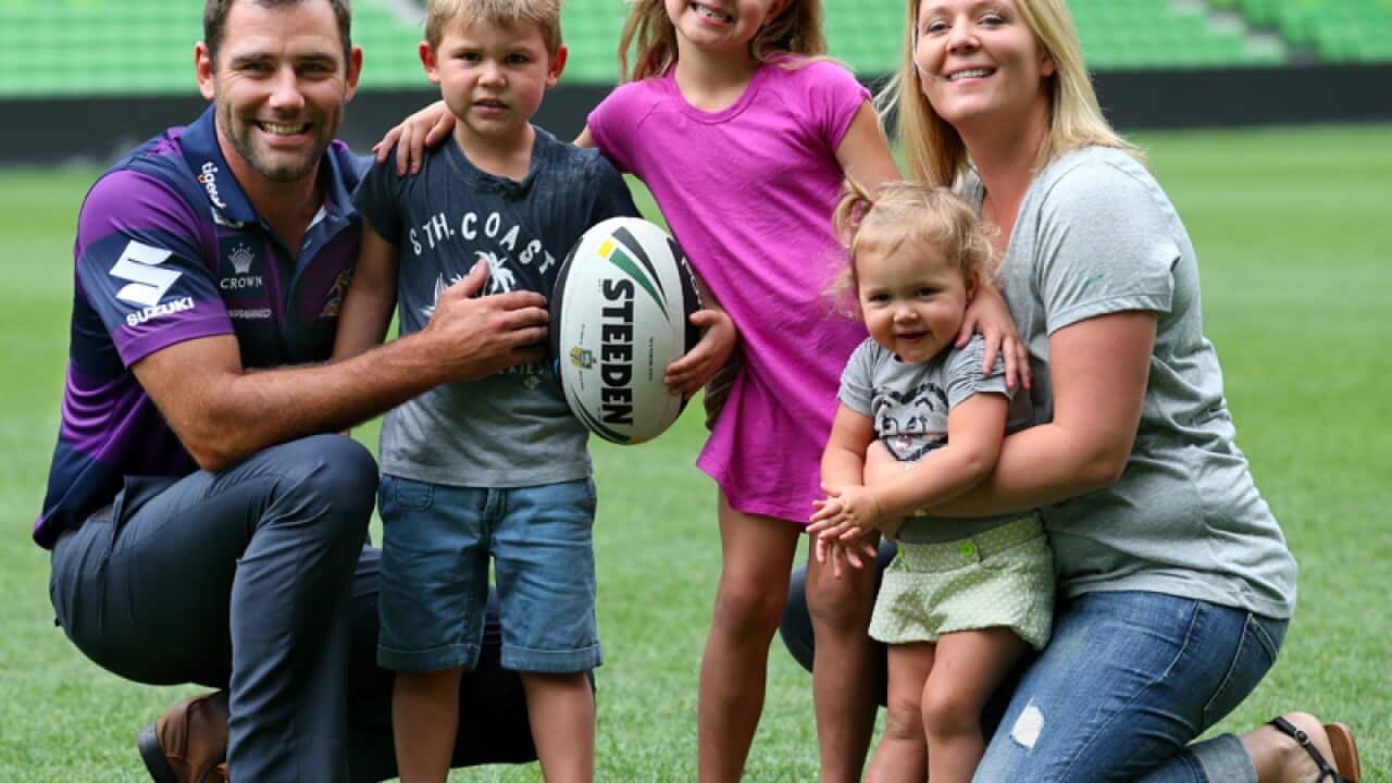 Melbourne Storm captain Cameron Smith (L) poses with his family