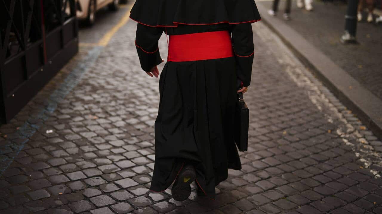 A cardinal walking the streets.