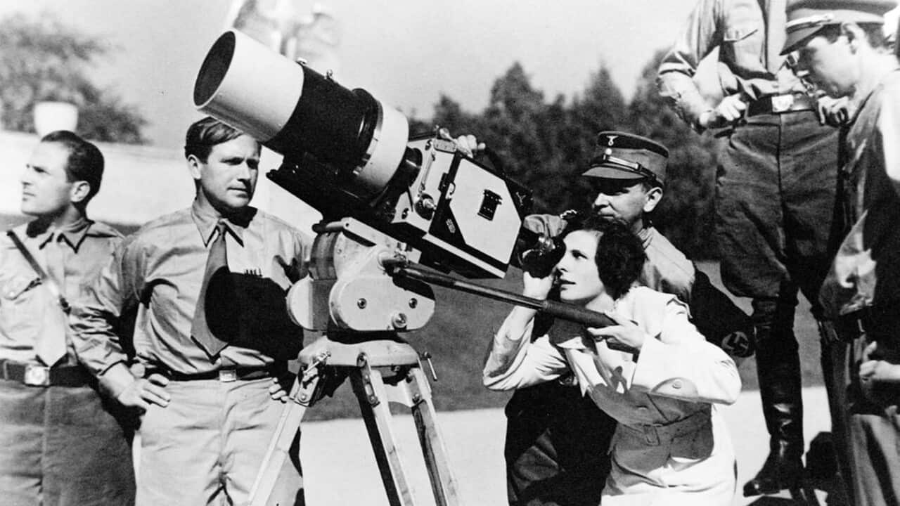 Leni Riefenstahl looking through the lens of a large camera prior to filming the 1934 Nuremberg Rally.