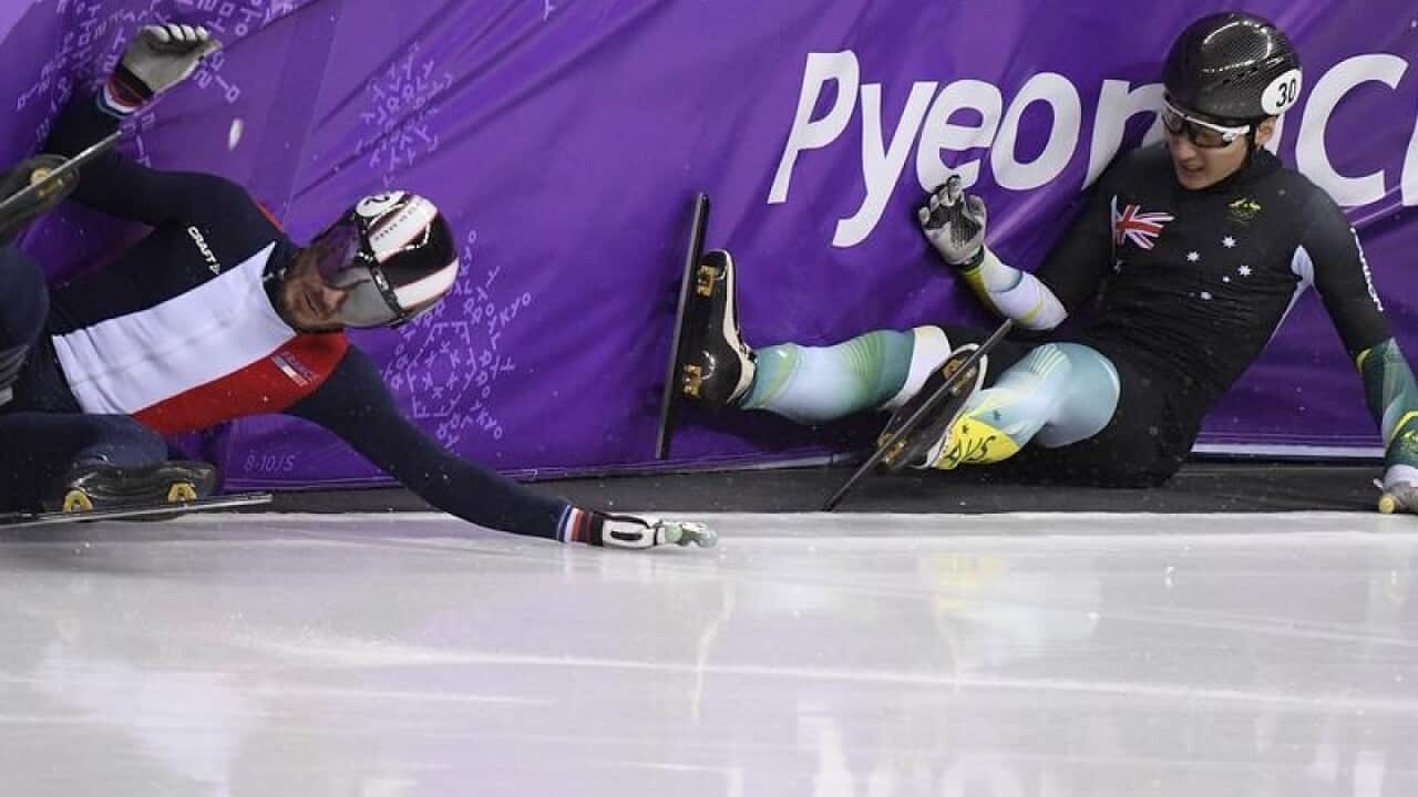 Australian skater Andy Jung (R) crashes out of his heat