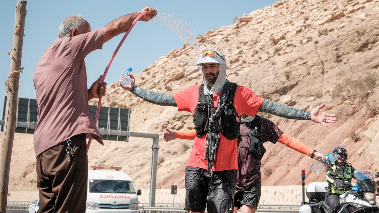 Tim Buxton getting sprayed with water in Shaqlawa during his marathon.jpg