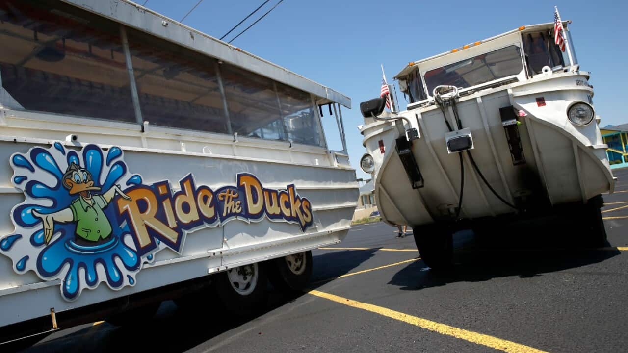 A man looks at an idled duck boat in the parking lot of Ride the Ducks Saturday, July 21, 2018 in Branson