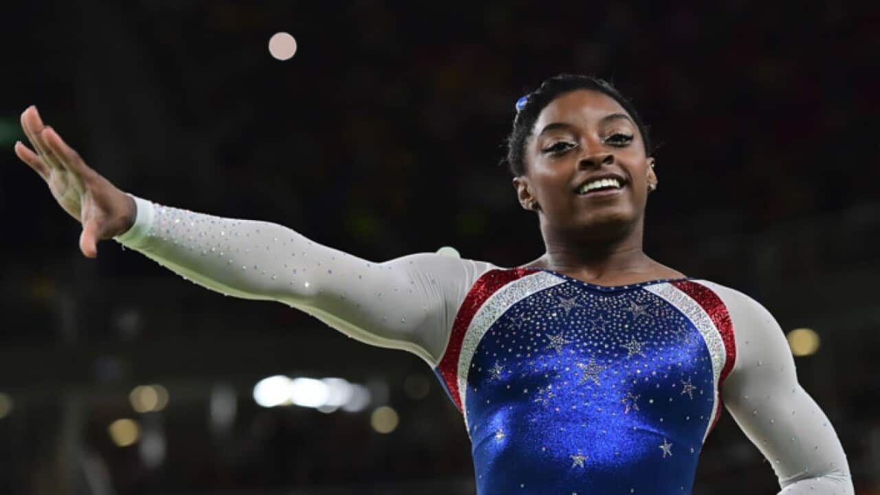 Gold medalist Simone Biles of the United States celebrates on the podium at the medal ceremony at the 2016 Rio Olympics