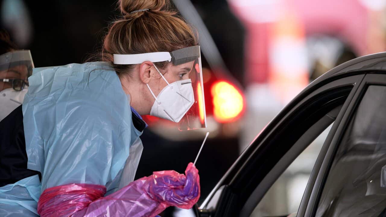 A nurse at a drive-thru location in Nebraska holds prepares to administer a test for the coronavirus.