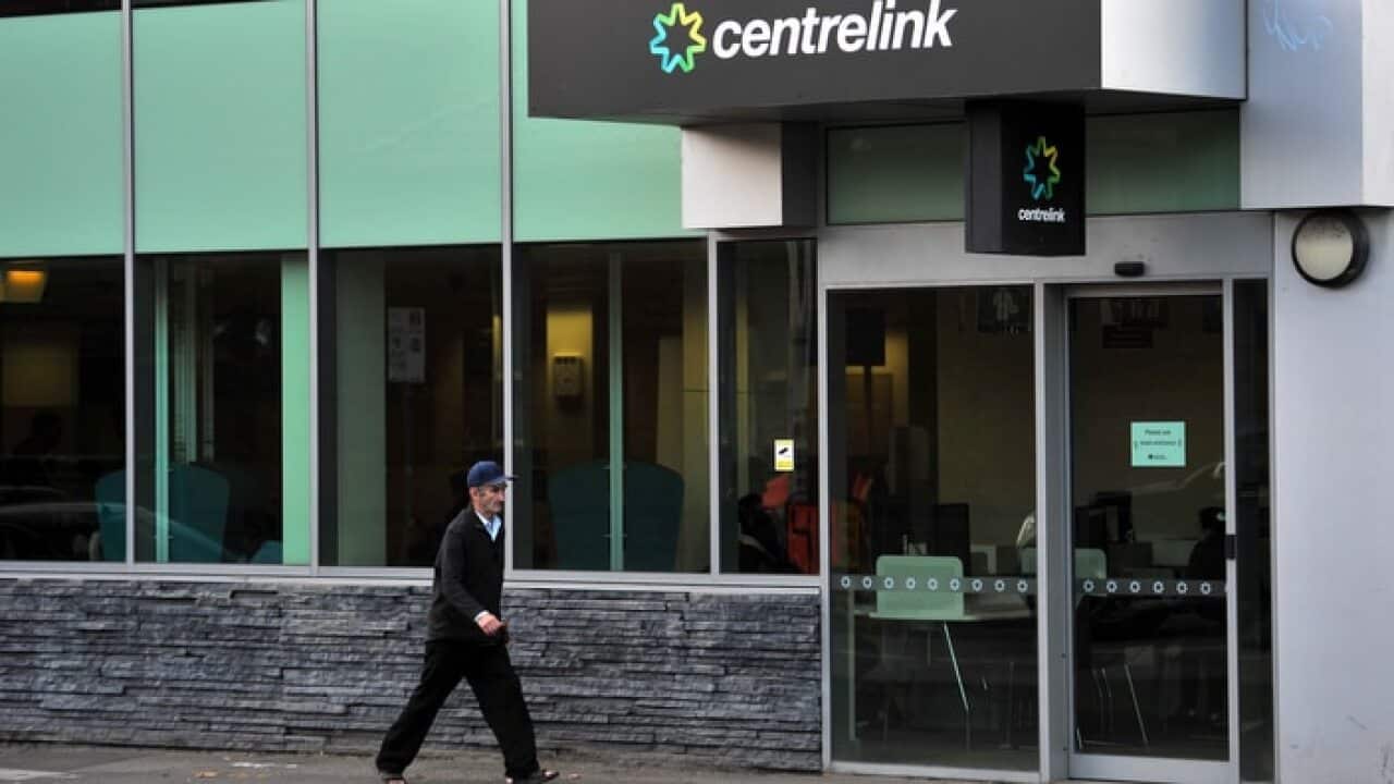 A man walks past a Centrelink branch in Melbourne