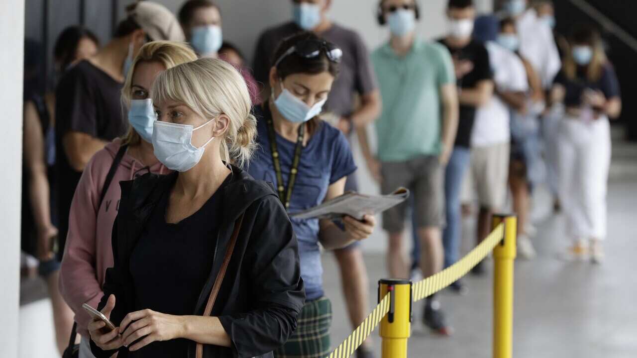 People wait in a line at a COVID-19 testing station on the northern beaches in Sydney