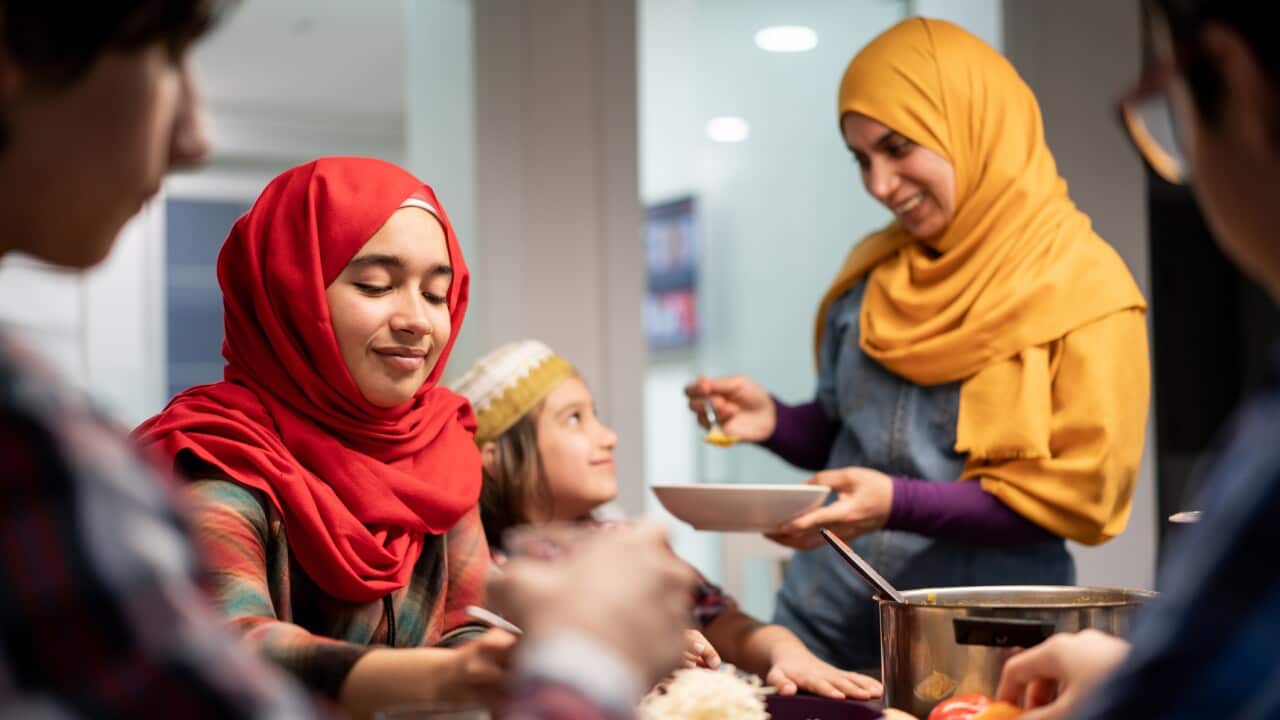 Muslim family eating Iftar and enjoying breaking of fasting.