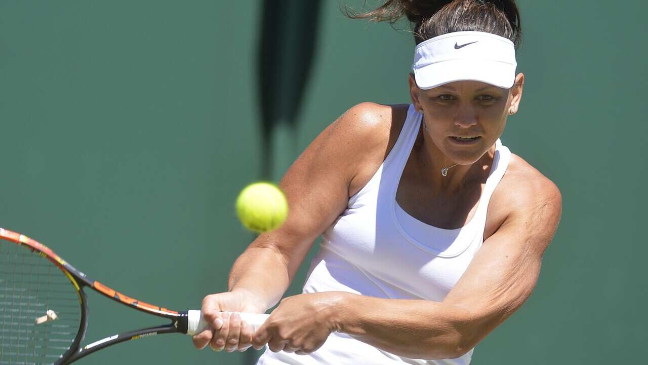 Casey Dellacqua of Australia returns to Tamira Paszek of Austria in their first round match at Wimbledon, 30 June 2015. (EPA/GERRY PENNY)