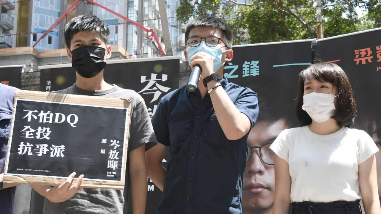 Pro-democracy activist Joshua Wong (C) makes a speech on a street in Hong Kong (AAP)