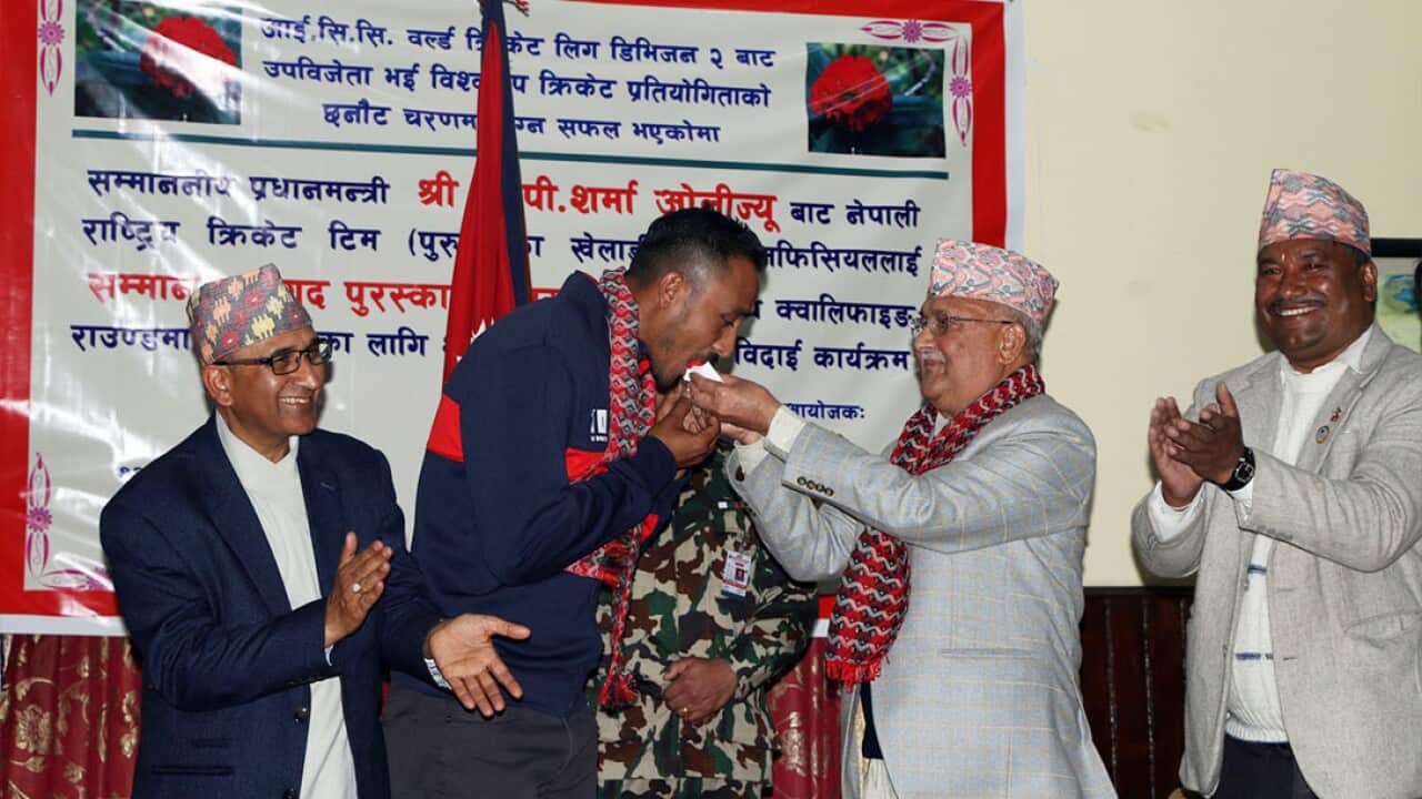 Nepali Cricket captain Paras Khadka eating cake from Prime Minister KP Sharma Oli in Kathmandu in February 2018.