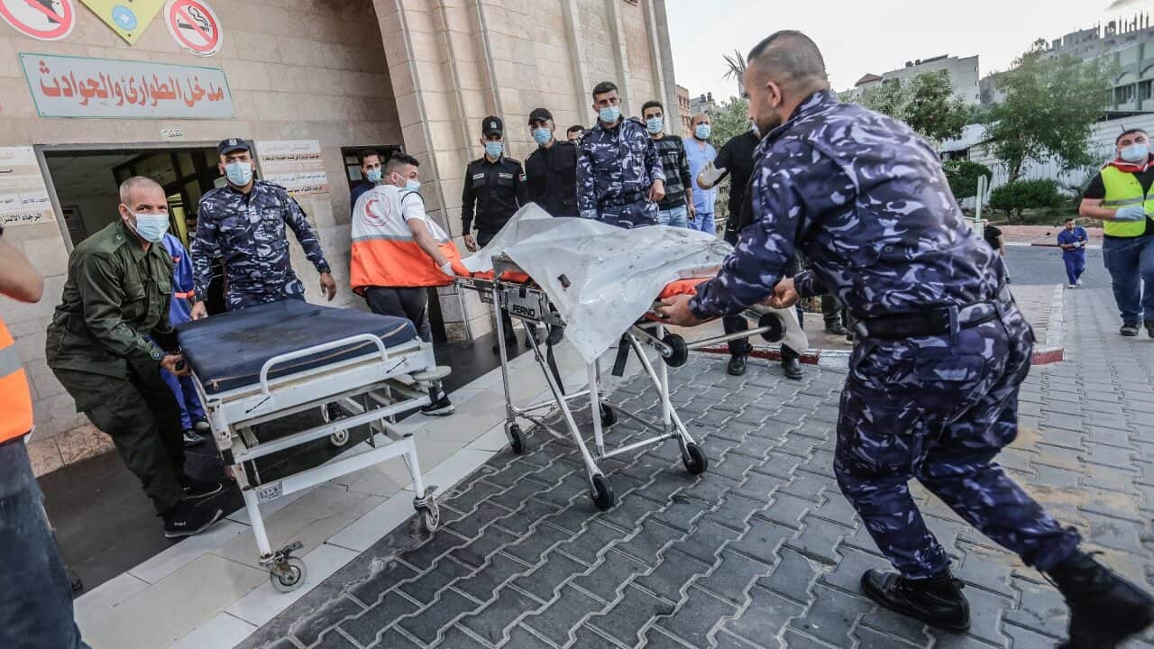 An injured Palestinian man is being brought to Al-Shifa hospital to receive treatment after an Israeli air strike in Gaza City.