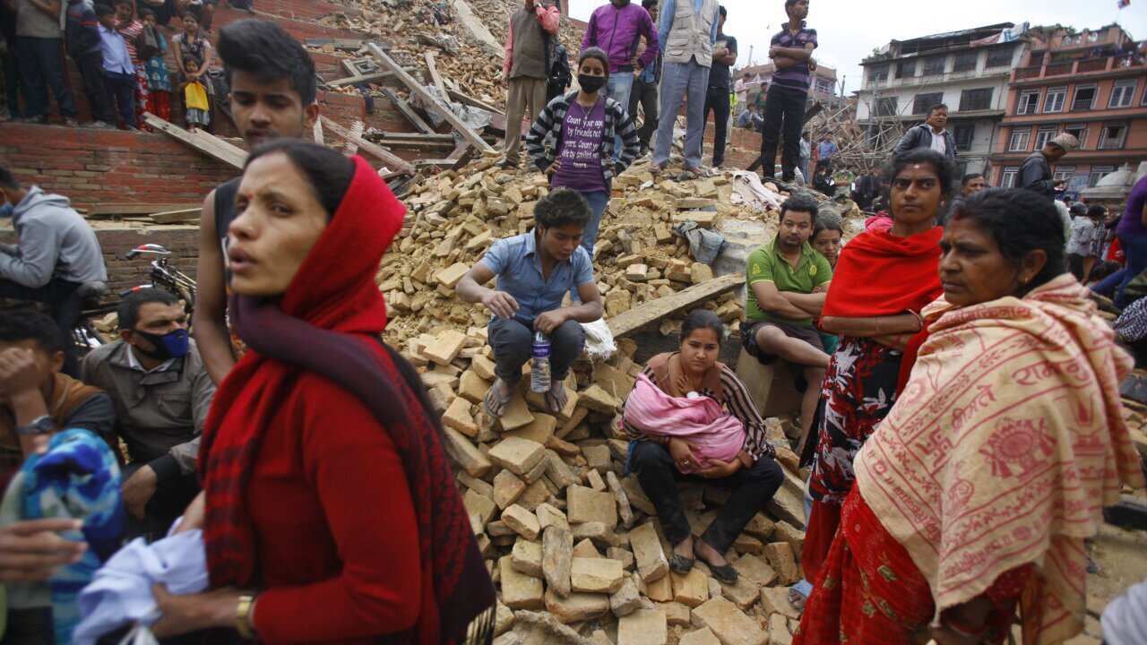 People rest on debris at Durbar Square after an earthquake in Kathmandu, Nepal, Saturday, April 25, 2015. (AP Photo/ Niranjan Shrestha)