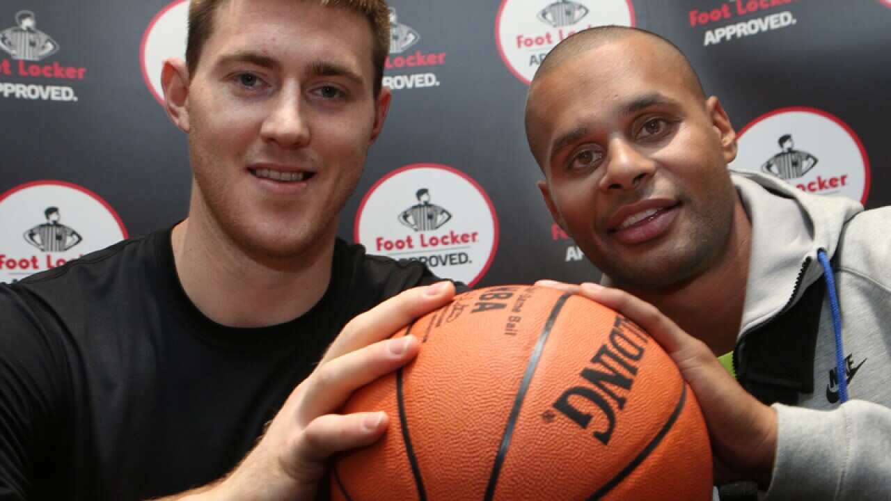 Australian San Antonio Spurs stars Aron Baynes (L) and Patty Mills