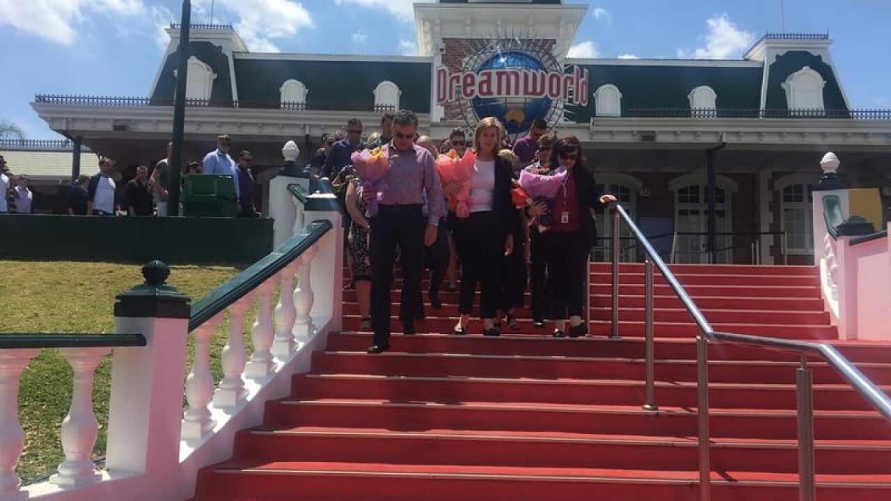 shot of people walking down steps with Dreamworld signage behind them