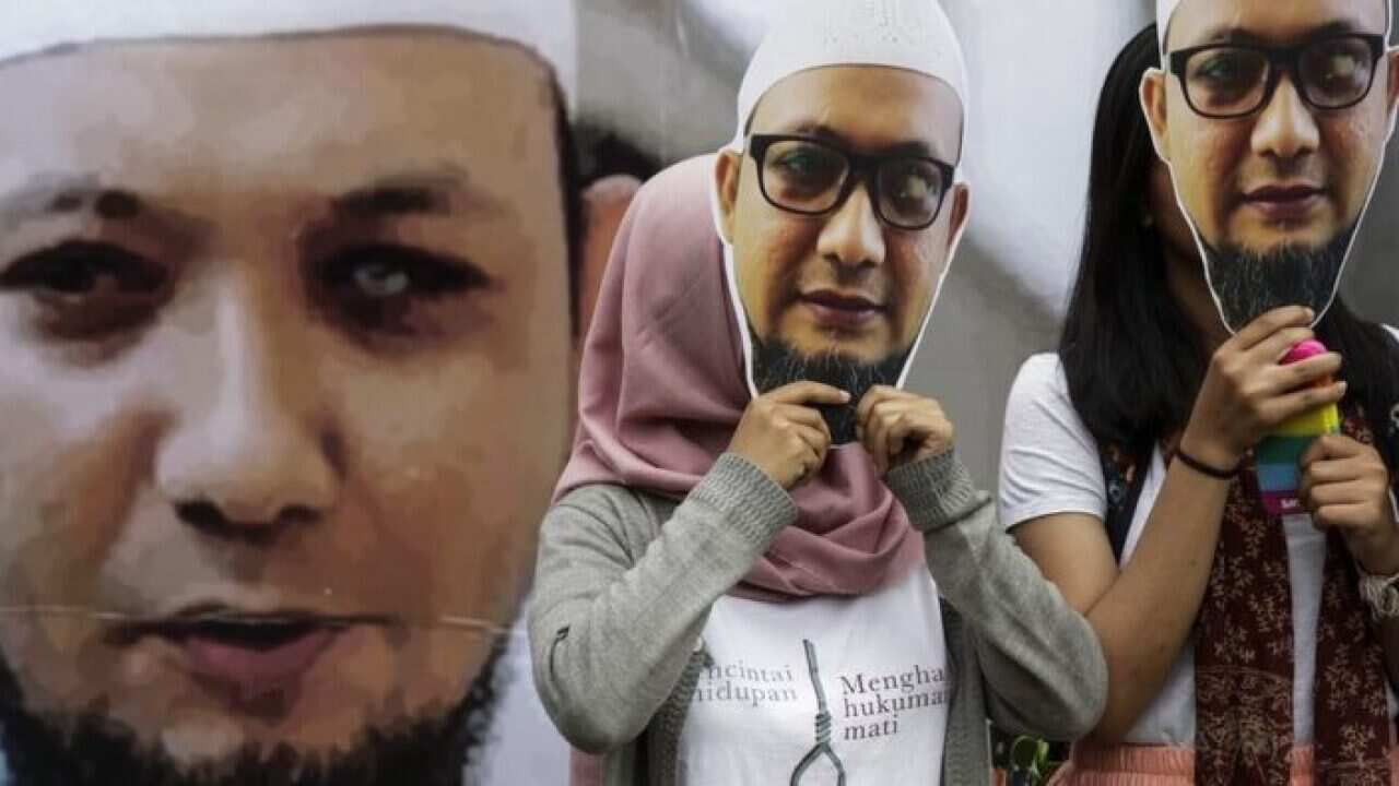 People put on masks of Novel Baswedan's face as a show of support.