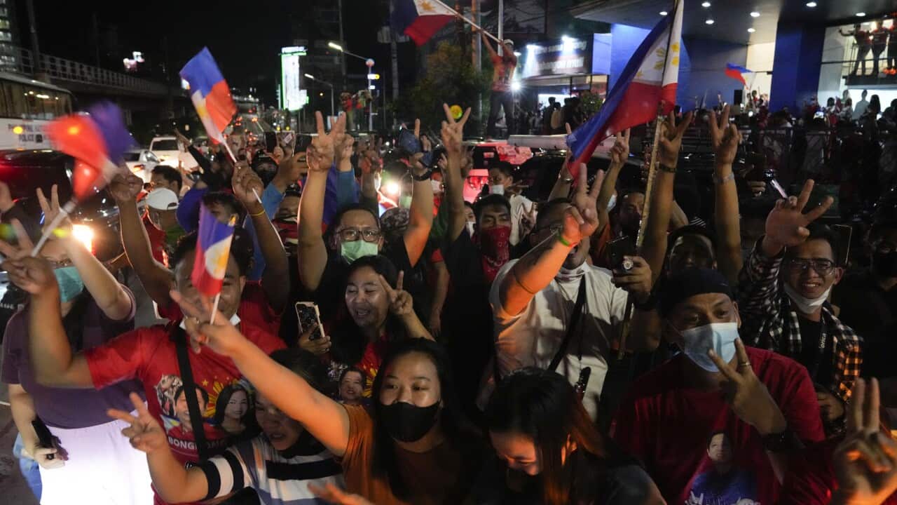 Supporters cheer as they arrive at the headquarters of Marcos Jr. in Mandaluyong, Philippines.