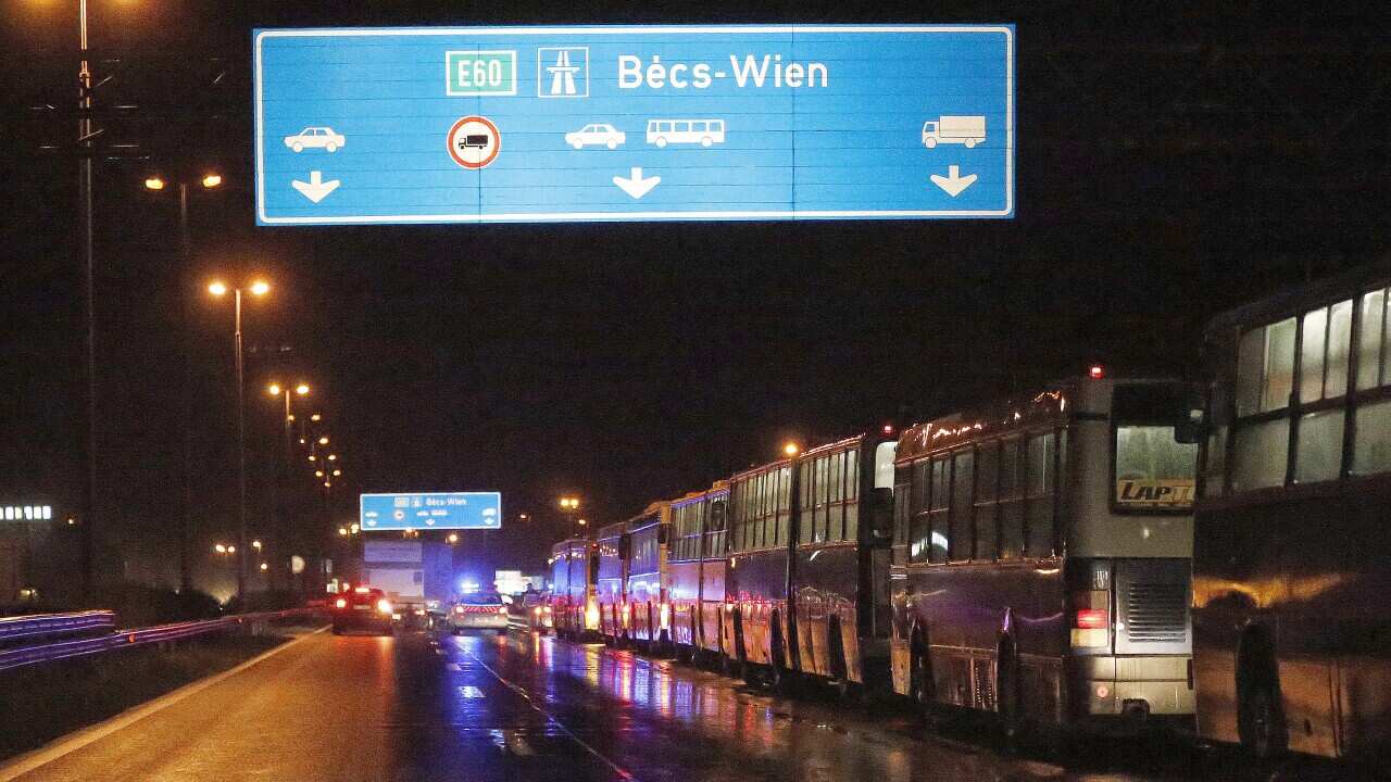 Busses with migrants queue at the border to Austria, Hungary. (AP)