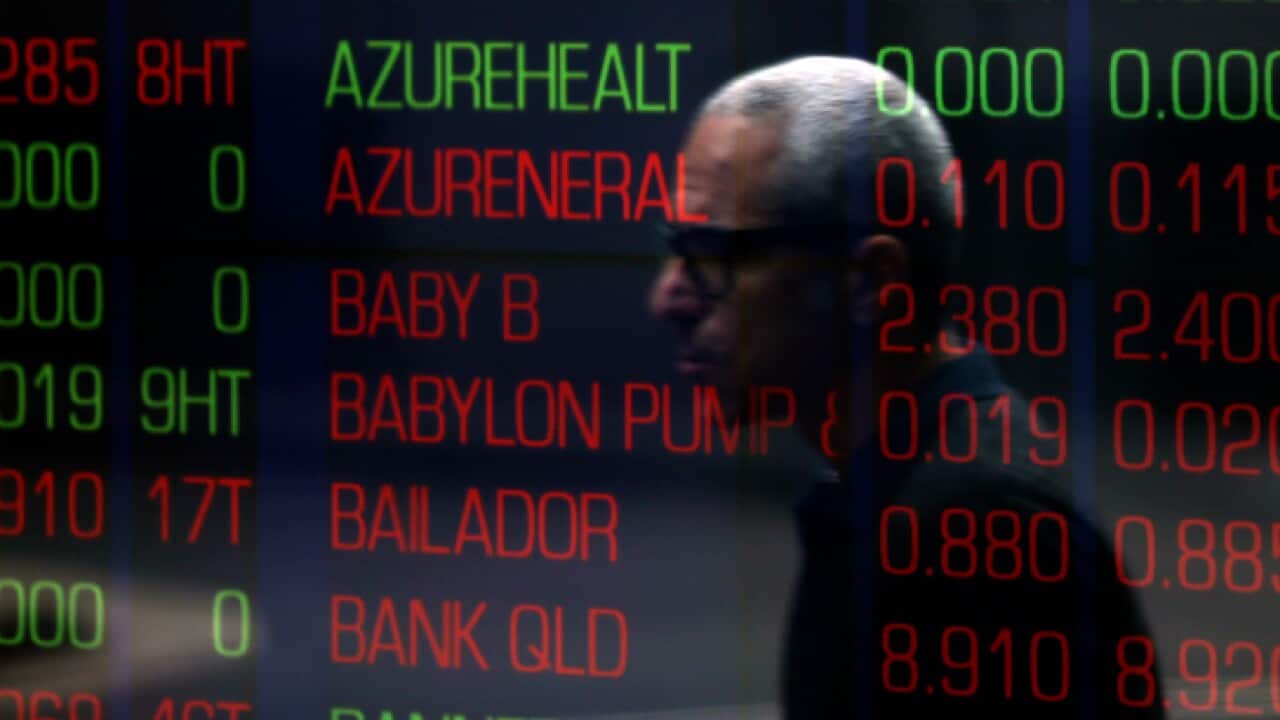 a man walks by the stock exchange