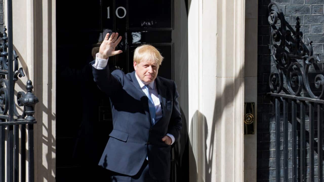 Britain's new Prime Minister Boris Johnson waves to photographers outside 10 Downing Street (AAP)