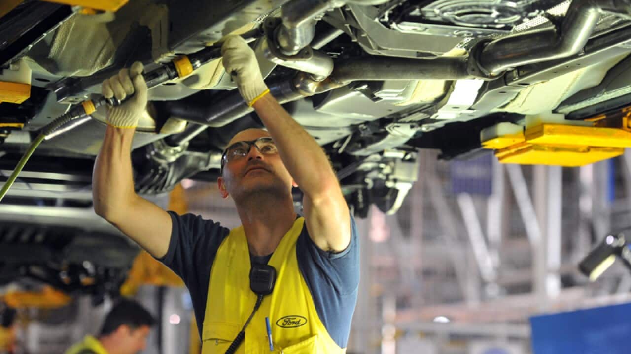 A worker on an assembly line at the Ford Manufacturing Plant