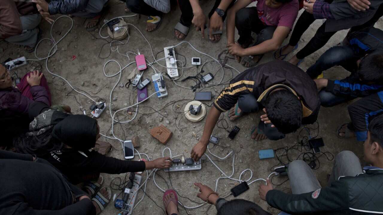 Nepalese villagers charge their phones