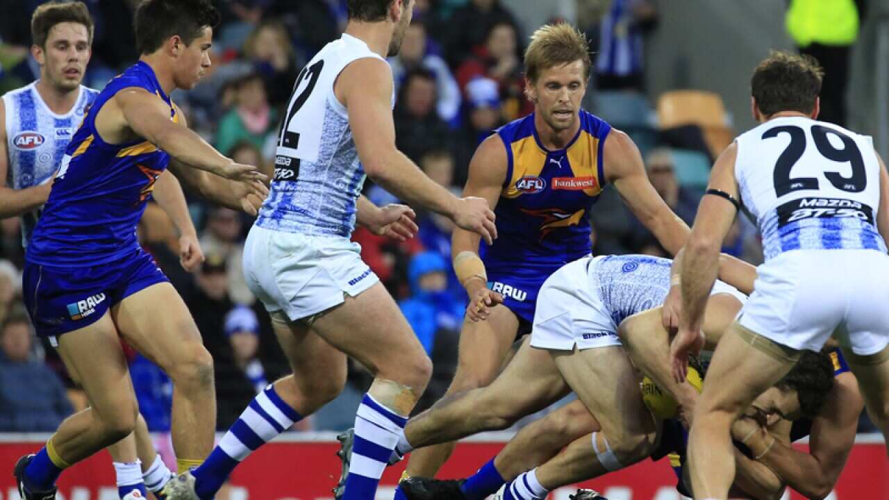 Tackle during AFL match between the Kangaroos and the Eagles