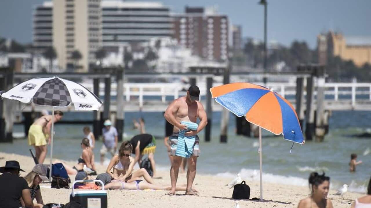 Beachgoers are seen at Kerferd Road beach in Melbourne