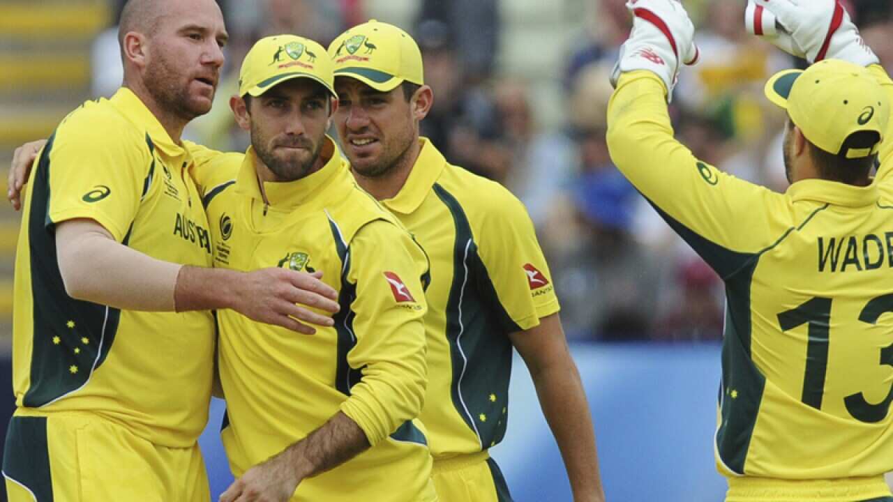 Australia's John Hastings, left, hugs teammate Glenn Maxwell