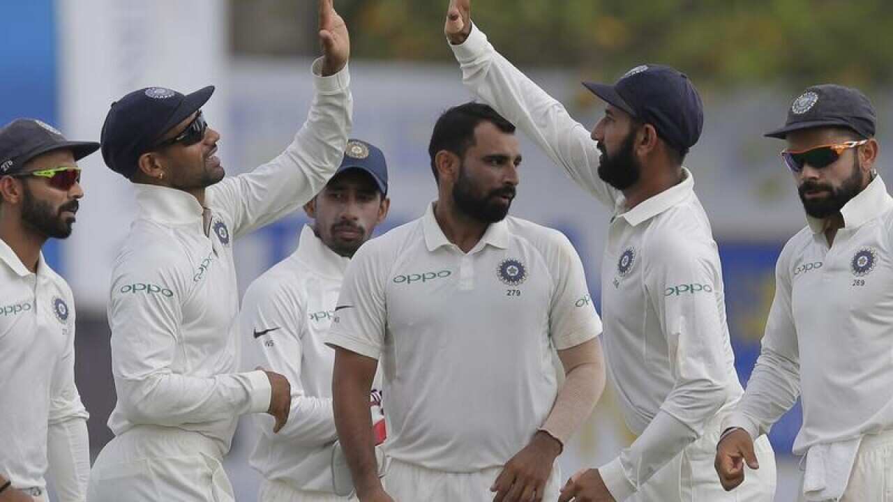 Indian players celebrate after claiming a wicket