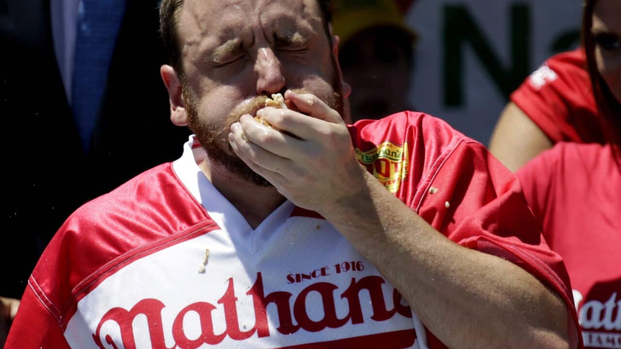 US Champion eater Joey Chestnut eats hot dogs as he participates in Nathan's Famous Fourth of July International Hot-dog eating contest 