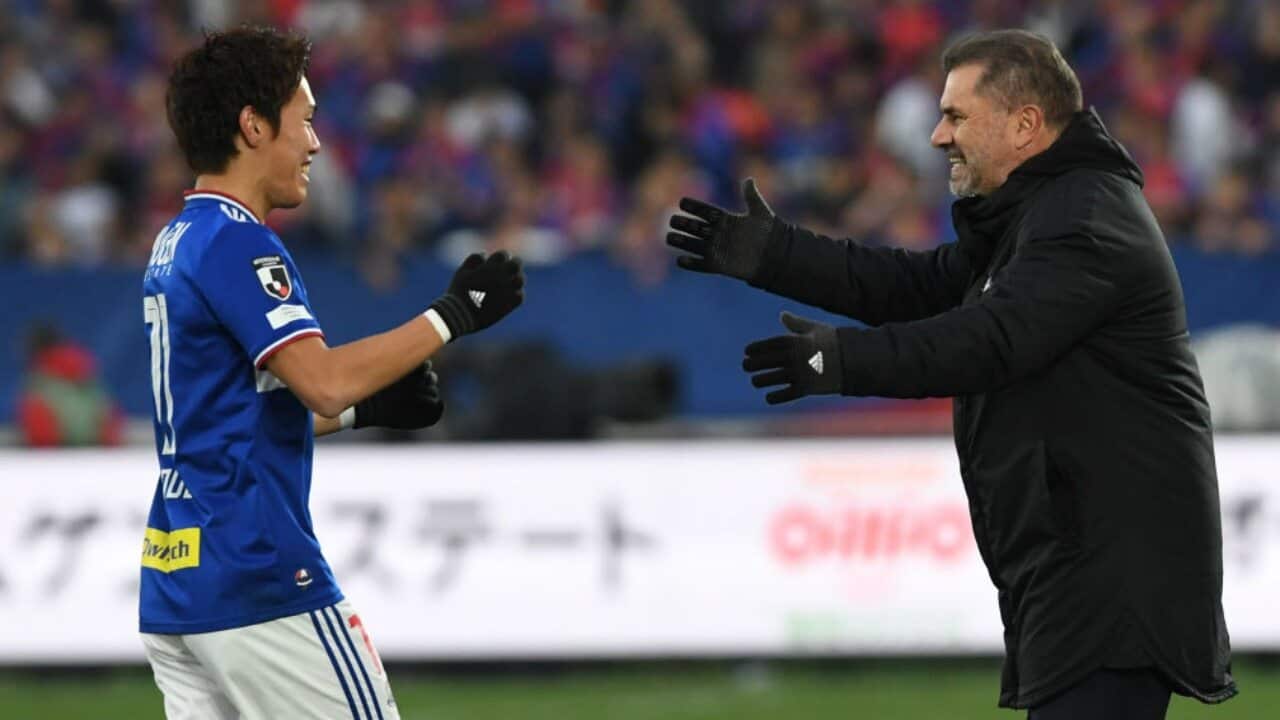Ange Postecoglou (R) celebrates a goal with Keita Endo