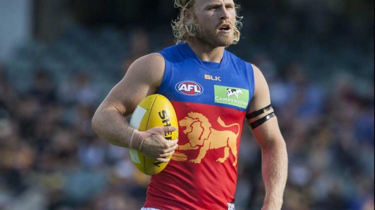 Brisbane's Daniel Rich prepares to kick