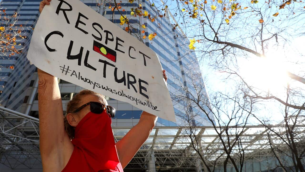 Protesters are seen during a rally outside the Rio Tinto office in Perth.