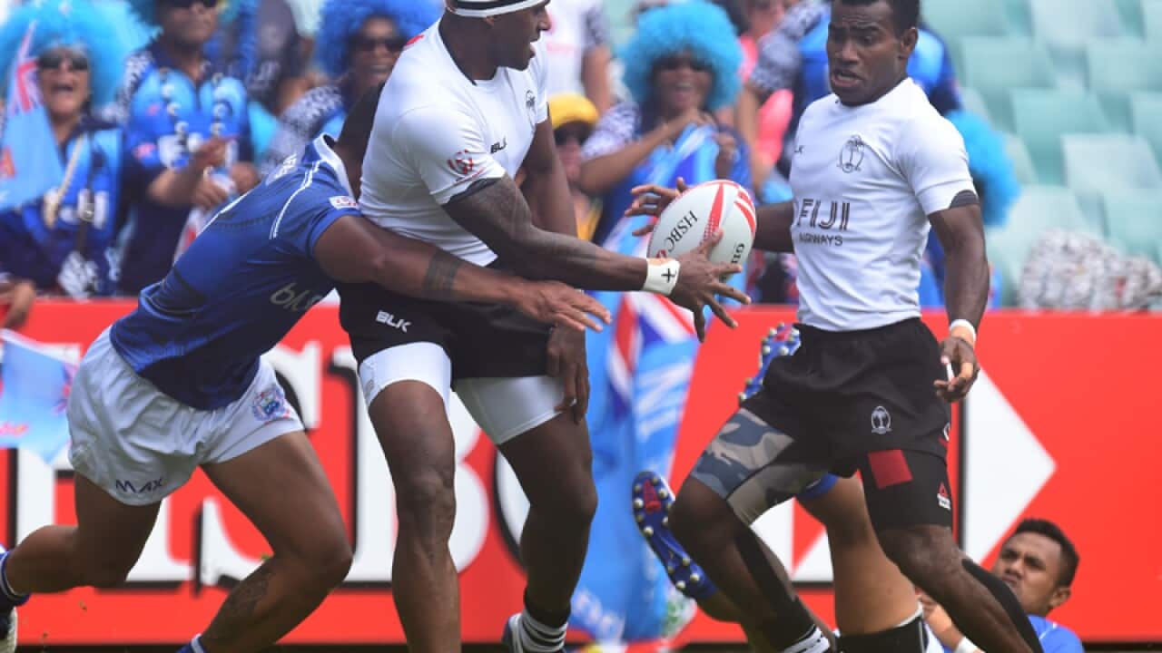 Semi Kunatani of Fiji off loads the ball